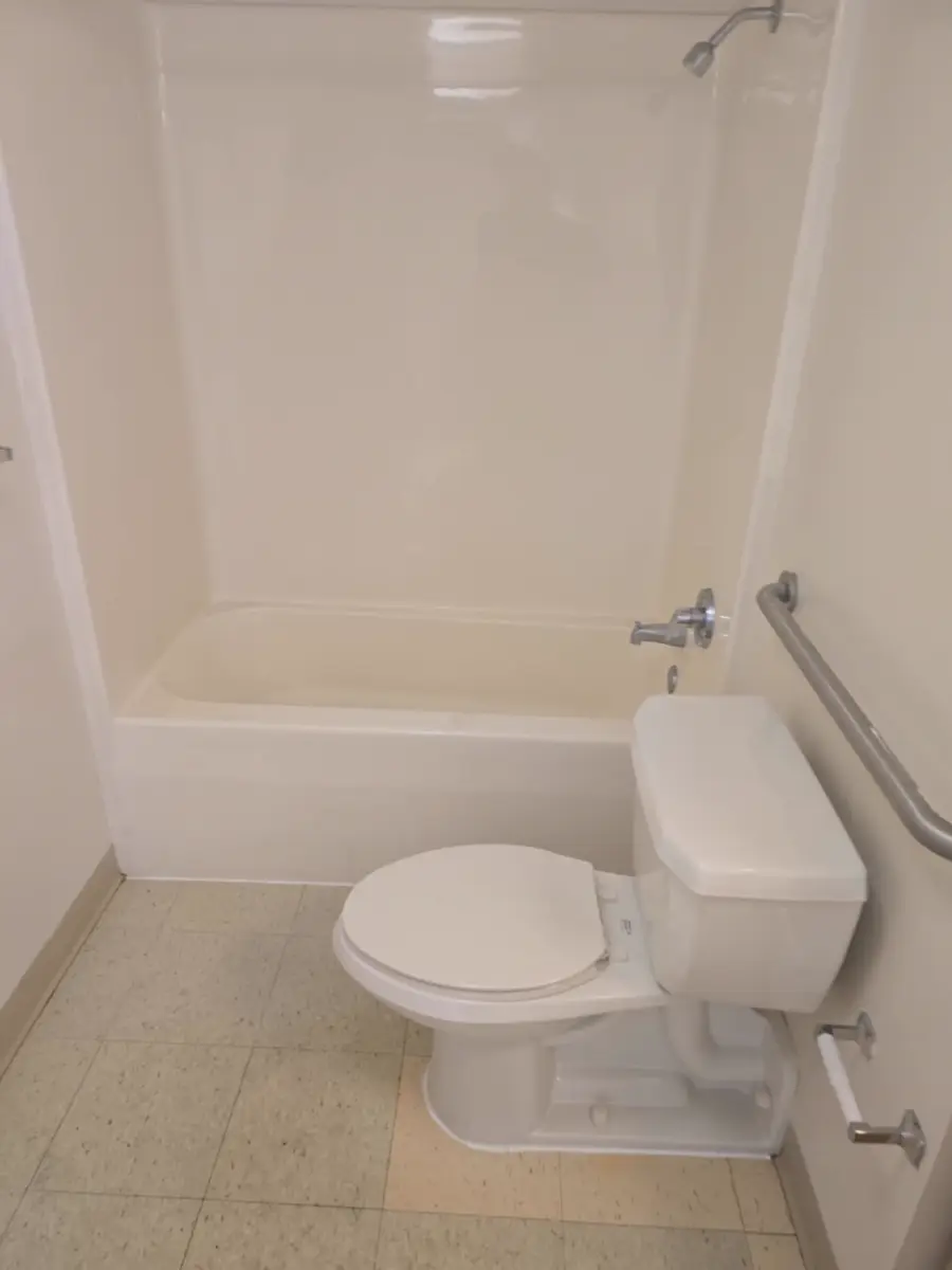Spotless restroom tub, toilet, and tile after a Metro Glow clean